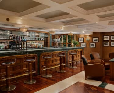 A bar with a row of beer pumps.