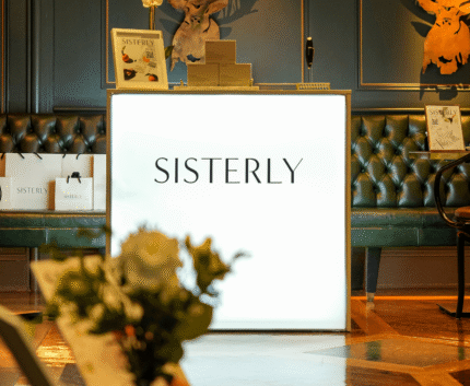 Elegant hotel lobby with plush seating, stylish deer decor, and soft lighting, inviting warmth and comfort.