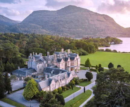 Luxury countryside hotel with scenic mountain and lake views, surrounded by lush greenery, ideal for tranquil getaways.